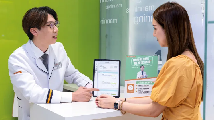 Mannings’ Pharmacist, Nathan Lam, helping a customer with the recently launched AI Wellness Scan service in Hong Kong